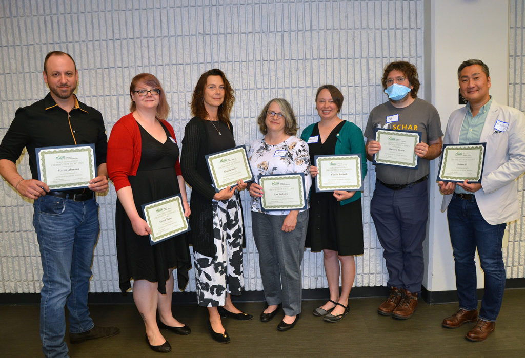 Academic Advisor of the Year top 10. Seven are pictured holding their Certificates of Excellence