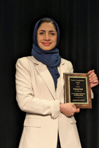 Shabnam Rezai holding the award for Patriot Inspiration
