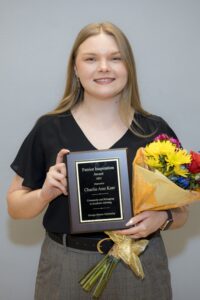 Charlie Ann Kerr holding the plaque for the Patriot Inspiration Award for 2025
